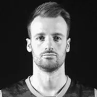 Un uomo indossa una maglia sportiva scura a collo a V, rappresentando abbigliamento sportivo personalizzato.