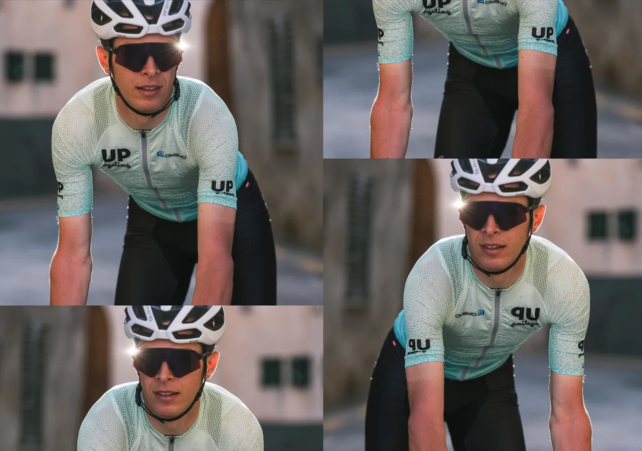 Un ciclista indossa una maglia azzurra con motivo, con il logo 'UP cycling' e il nome del marchio 'owayo' sul petto, mentre guida una bicicletta.